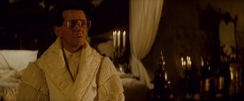 Movie still from “Blade Runner” (1982), directed by Ridley Scott – An old man wearing a white robe and glasses; Medium shot, Low angle