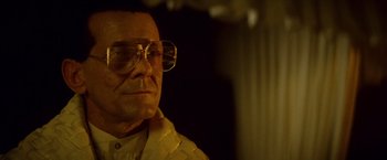 Movie still from “Blade Runner” (1982), directed by Ridley Scott – An older man wearing glasses and a white shirt; Close Up shot, Low angle