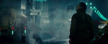 Movie still from “Blade Runner” (1982), directed by Ridley Scott – A man standing on the side of a road in the middle of the night; Medium shot, Low angle