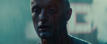 Movie still from “Blade Runner” (1982), directed by Ridley Scott – A person with blood on his face; Close Up shot, Low angle