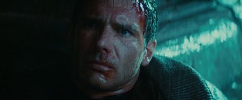 Movie still from “Blade Runner” (1982), directed by Ridley Scott – A man's face with blood on his face; Close Up shot, Low angle