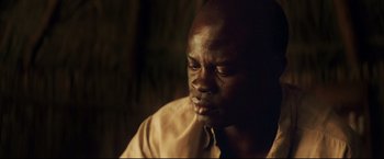 Movie still from “Blood Diamond” (2006), directed by Edward Zwick – A person wearing a shirt and tie; Close Up shot, Over the shoulder angle