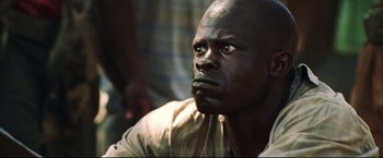 Movie still from “Blood Diamond” (2006), directed by Edward Zwick – A person with a black face; Close Up shot, Low angle