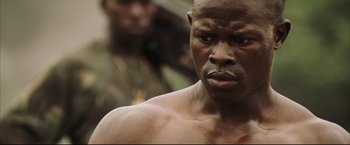 Movie still from “Blood Diamond” (2006), directed by Edward Zwick – A person with a face covered in dirt; Close Up shot, Low angle