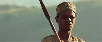 Movie still from “Blood Diamond” (2006), directed by Edward Zwick – A man holding an arrow in his hand; Close Up shot, Low angle