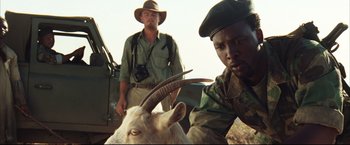 Movie still from “Blood Diamond” (2006), directed by Edward Zwick – Two men standing next to an animal with horns on it; Close Up shot, Low angle