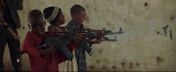 Movie still from “Blood Diamond” (2006), directed by Edward Zwick – Two young children are holding guns in their hands; Medium shot, Low angle