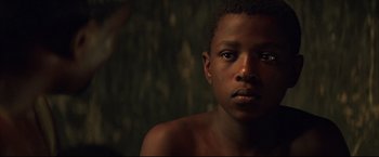 Movie still from “Blood Diamond” (2006), directed by Edward Zwick – A person with a bare chest; Close Up shot, Over the shoulder angle