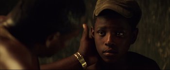 Movie still from “Blood Diamond” (2006), directed by Edward Zwick – A person wearing a hat; Close Up shot, Over the shoulder angle
