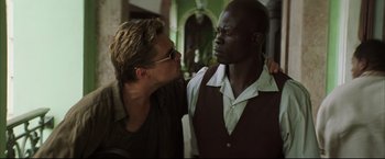 Movie still from “Blood Diamond” (2006), directed by Edward Zwick – A man and a woman standing next to each other; Close Up shot, Over the shoulder angle
