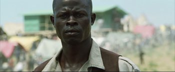 Movie still from “Blood Diamond” (2006), directed by Edward Zwick – A person wearing a white shirt; Close Up shot, Low angle