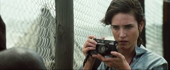 Movie still from “Blood Diamond” (2006), directed by Edward Zwick – A person taking a picture with an old camera; Close Up shot, Low angle