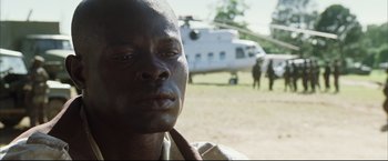 Movie still from “Blood Diamond” (2006), directed by Edward Zwick – A person with a helicopter in the background; Close Up shot, Low angle