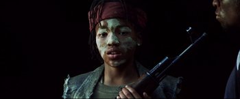 Movie still from “Blood Diamond” (2006), directed by Edward Zwick – A person with a gun in their hand; Close Up shot, Low angle