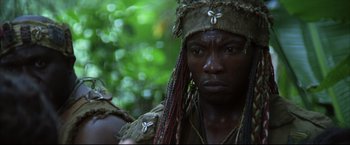 Movie still from “Blood Diamond” (2006), directed by Edward Zwick – A person with dreadlocks wearing a headdress; Close Up shot, Low angle