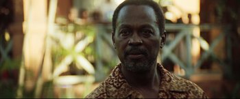 Movie still from “Blood Diamond” (2006), directed by Edward Zwick – A person wearing a shirt; Close Up shot, Over the shoulder angle