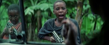 Movie still from “Blood Diamond” (2006), directed by Edward Zwick – A young boy holding a gun in his hand; Close Up shot, Low angle
