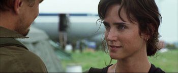 Movie still from “Blood Diamond” (2006), directed by Edward Zwick – A woman's face in front of an airplane; Close Up shot, Over the shoulder angle