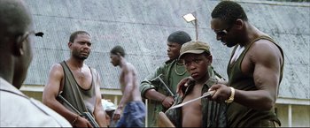 Movie still from “Blood Diamond” (2006), directed by Edward Zwick – A group of young men standing next to each other; Medium shot, Low angle