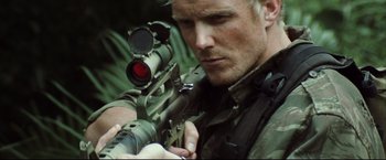 Movie still from “Blood Diamond” (2006), directed by Edward Zwick – A person holding a rifle; Close Up shot, Low angle