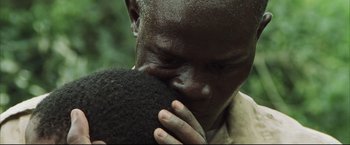 Movie still from “Blood Diamond” (2006), directed by Edward Zwick – A person holding something to his face; Extreme Close Up shot, Low angle