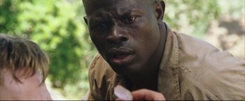 Movie still from “Blood Diamond” (2006), directed by Edward Zwick – A person holding something in his hand; Close Up shot, High angle