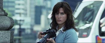 Movie still from “Blood Diamond” (2006), directed by Edward Zwick – A beautiful woman holding a camera in her hands; Close Up shot, Over the shoulder angle