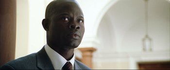 Movie still from “Blood Diamond” (2006), directed by Edward Zwick – A man in a suit and tie; Close Up shot, Low angle