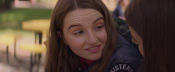 Movie still from “Booksmart” (2019), directed by Olivia Wilde – A person sitting down smiling; Close Up shot, Over the shoulder angle