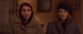 Movie still from “Booksmart” (2019), directed by Olivia Wilde – Two people sitting in a room with a painting on the wall behind them; Close Up shot, Over the shoulder angle