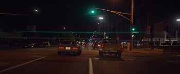 Movie still from “Booksmart” (2019), directed by Olivia Wilde – Cars are stopped at a red light at night; Extreme Wide shot, Low angle