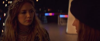 Movie still from “Booksmart” (2019), directed by Olivia Wilde – A woman in a leopard print coat standing in front of a window; Close Up shot, Over the shoulder angle