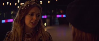 Movie still from “Booksmart” (2019), directed by Olivia Wilde – A woman in a leopard print jacket is talking to a man; Close Up shot, Over the shoulder angle