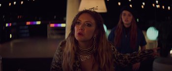 Movie still from “Booksmart” (2019), directed by Olivia Wilde – A woman with long red hair wearing a crown; Close Up shot, Over the shoulder angle