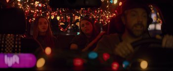 Movie still from “Booksmart” (2019), directed by Olivia Wilde – A woman sitting in the back of a vehicle; Medium shot, Over the shoulder angle