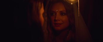 Movie still from “Booksmart” (2019), directed by Olivia Wilde – A beautiful woman with a green dot on her forehead; Close Up shot, Over the shoulder angle