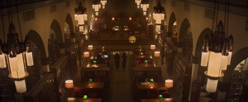 Movie still from “Booksmart” (2019), directed by Olivia Wilde – Two people are standing in a room with tables and chairs; Extreme Wide shot, High angle