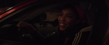 Movie still from “Booksmart” (2019), directed by Olivia Wilde – A woman sitting in the driver's seat of a car at night; Close Up shot, Over the shoulder angle