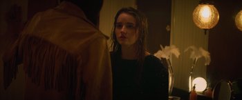 Movie still from “Booksmart” (2019), directed by Olivia Wilde – A young woman standing in front of a bathroom mirror; Close Up shot, Over the shoulder angle