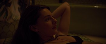 Movie still from “Booksmart” (2019), directed by Olivia Wilde – A beautiful young lady laying on the ground; Close Up shot, High angle