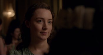 Movie still from “Brooklyn” (2015), directed by John Crowley – A woman with blue eyes is looking at the camera; Close Up shot, Over the shoulder angle