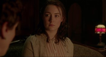 Movie still from “Brooklyn” (2015), directed by John Crowley – A woman in a striped shirt and a sweater; Close Up shot, Over the shoulder angle