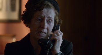 Movie still from “Brooklyn” (2015), directed by John Crowley – An older woman holding a phone up to her ear; Close Up shot, Over the shoulder angle