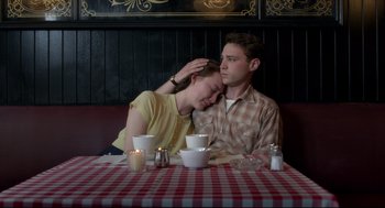 Movie still from “Brooklyn” (2015), directed by John Crowley – A man and a woman sitting at a table with candles; Medium shot, High angle