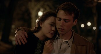 Movie still from “Brooklyn” (2015), directed by John Crowley – A man and a woman embracing each other in the dark; Close Up shot, Low angle
