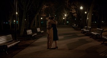 Movie still from “Brooklyn” (2015), directed by John Crowley – A man and a woman hugging on a sidewalk; Wide shot, High angle