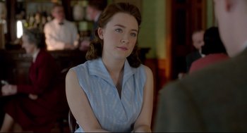 Movie still from “Brooklyn” (2015), directed by John Crowley – A woman sitting at a table in front of a man; Close Up shot, Over the shoulder angle