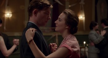Movie still from “Brooklyn” (2015), directed by John Crowley – A man and a woman dancing together in a room; Close Up shot, Low angle