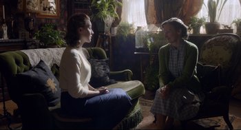 Movie still from “Brooklyn” (2015), directed by John Crowley – Two women sitting on a chair in a living room; Medium shot, Over the shoulder angle