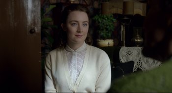 Movie still from “Brooklyn” (2015), directed by John Crowley – A woman in a white shirt and sweater; Medium shot, Over the shoulder angle